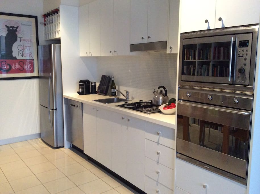 Fully equipped kitchen with Smeg gas stove, oven, microwave , Bosch dishwasher.