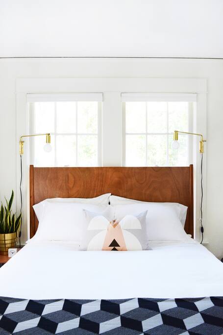 Comfortable queen sized mattress with crisp white bedding and a comfy down comfortable.