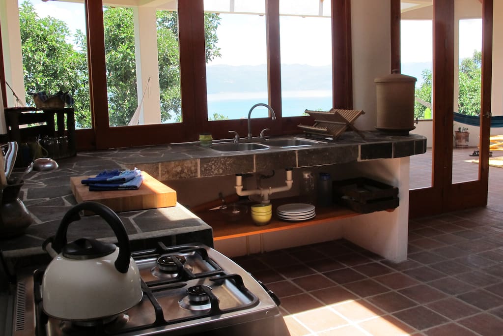 The kitchen comes fully equipped with an oven, full fridge (not pictured), baking sheets, cooking utensils, pots, pans, a pitcher, a kettle, a blender and a cast iron pan.