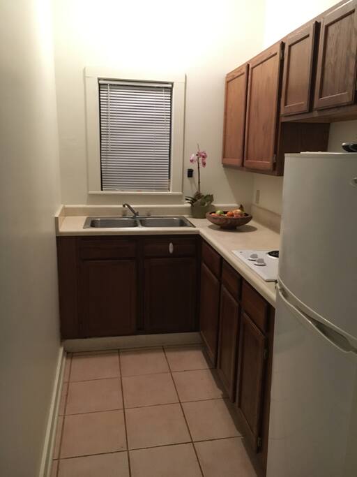 Kitchen equipped with microwave, plates, etc.