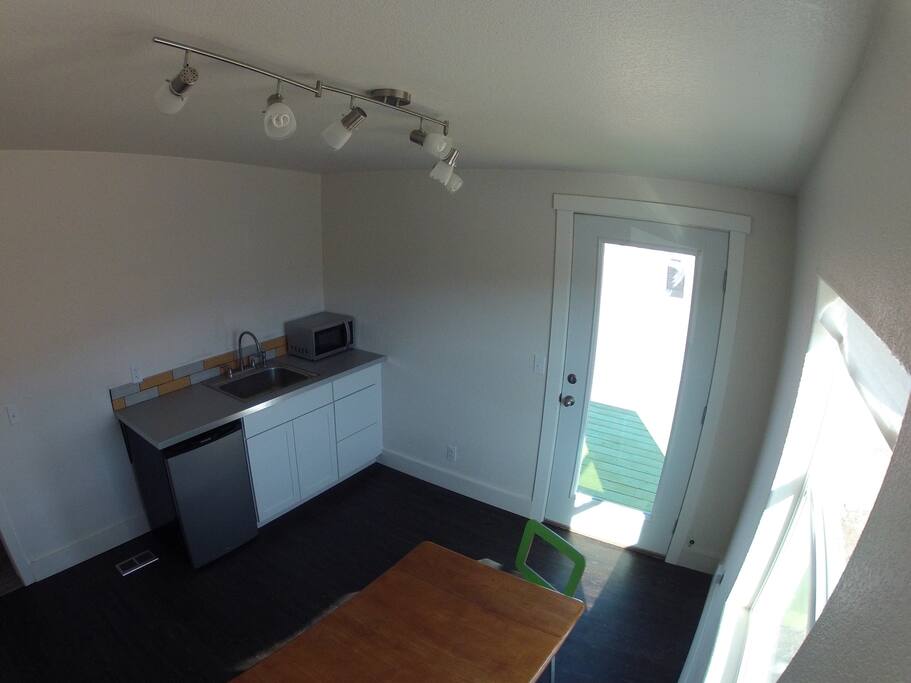 Kitchen dining area with guest entrance.