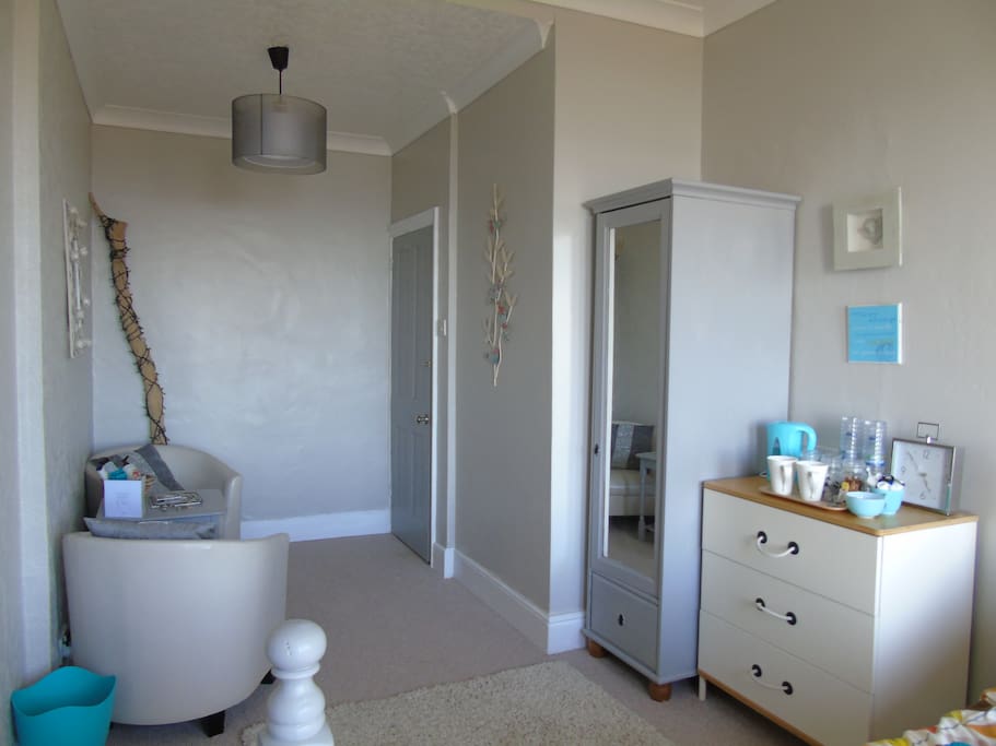 The bedroom has storage if you need it plus a couple of tub chairs to relax in.