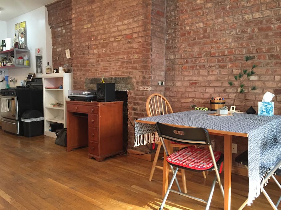 A side shot showing the kitchen, the record player unit and the dining table.