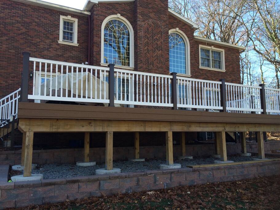 With huge elevated deck + patio + sprawling backyard
