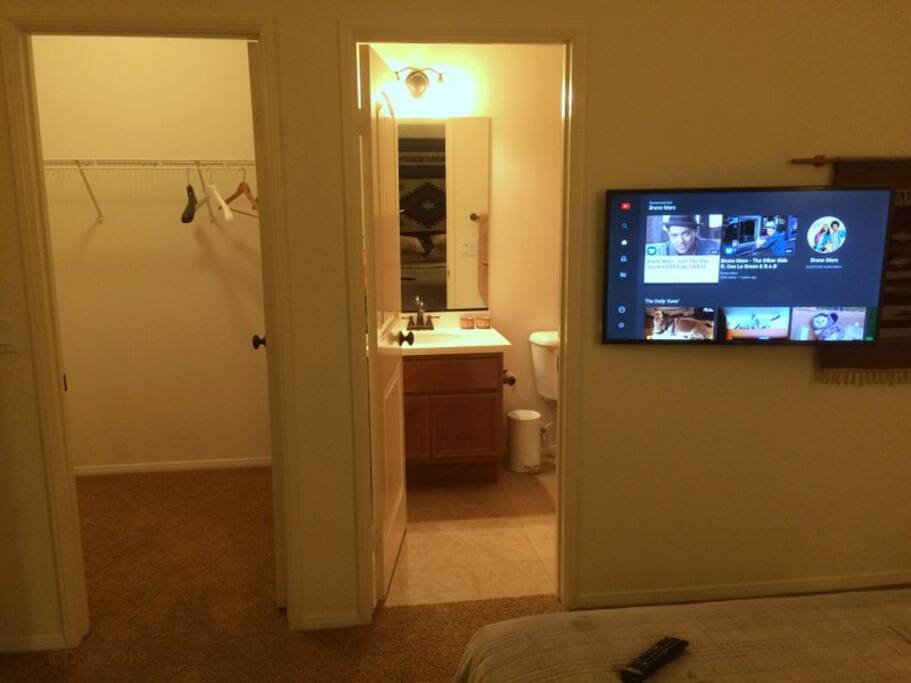 Smart TV, and doors to private bath & closet.