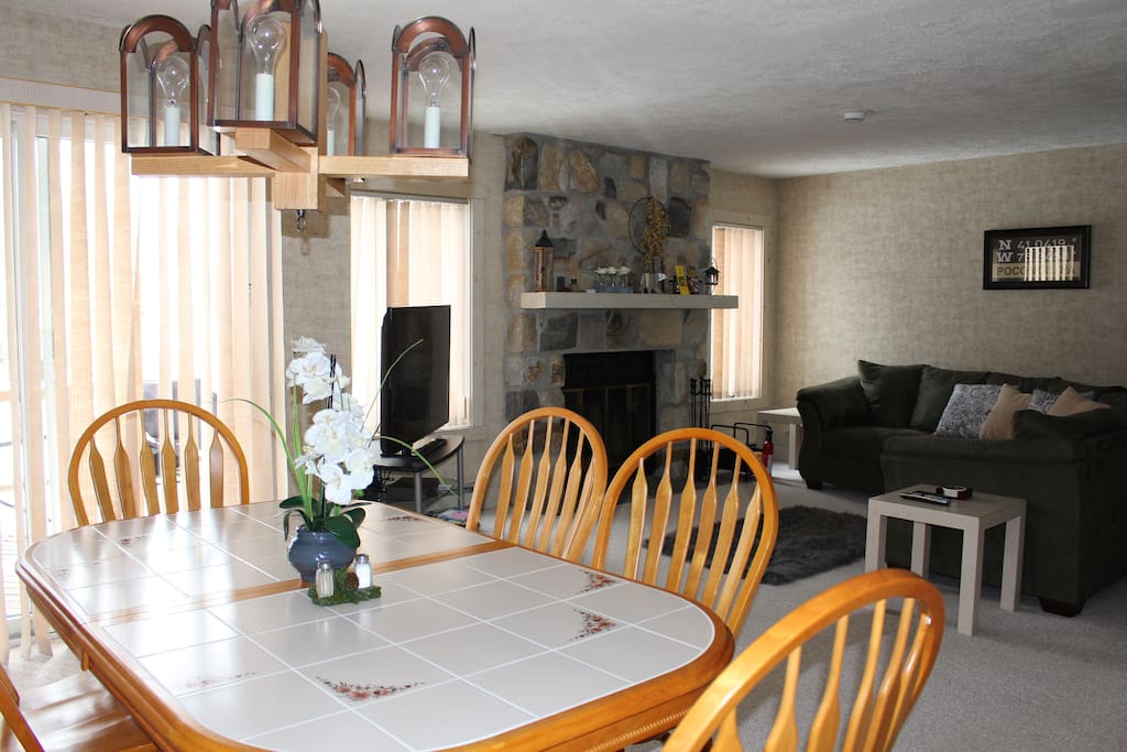 Living/Dining Combo with wood burning fireplace and TV