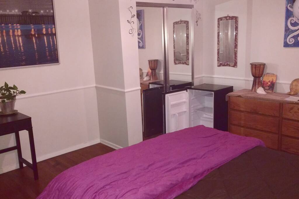 A shot of your room with small fridge, plenty of drawers, closet, and desk.