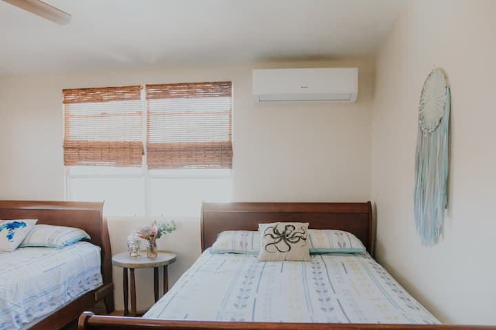Bedroom 2 has two queen sized beds, air conditioning and lots of sunlight.
