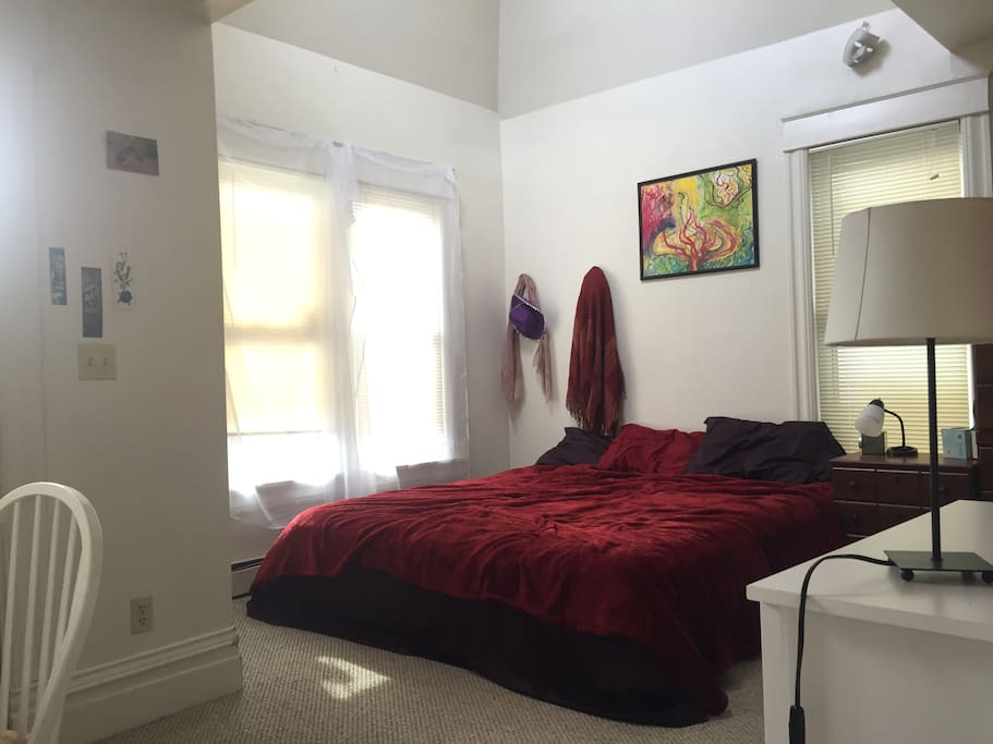 Master bedroom with King sized bed, a writing desk and doorway onto our balcony.