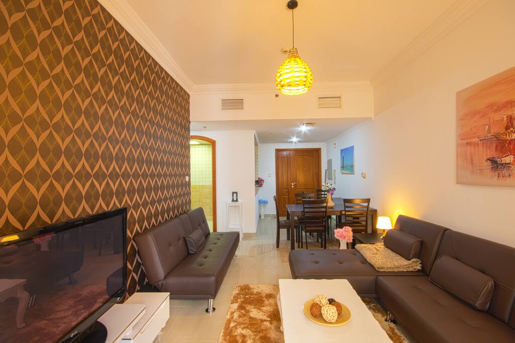 Large living room with 3 sleep sofas and a large dining table for 9 persons.