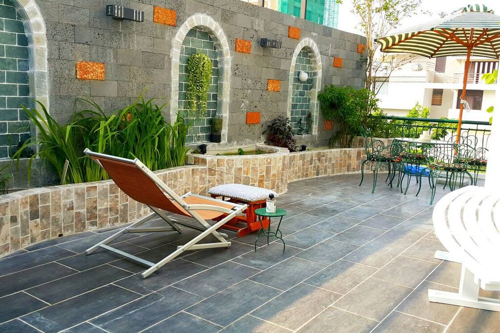 Terrace in the 1st floor where you can sit to enjoy your drink or take a sunbath with many flowers are blooming around 