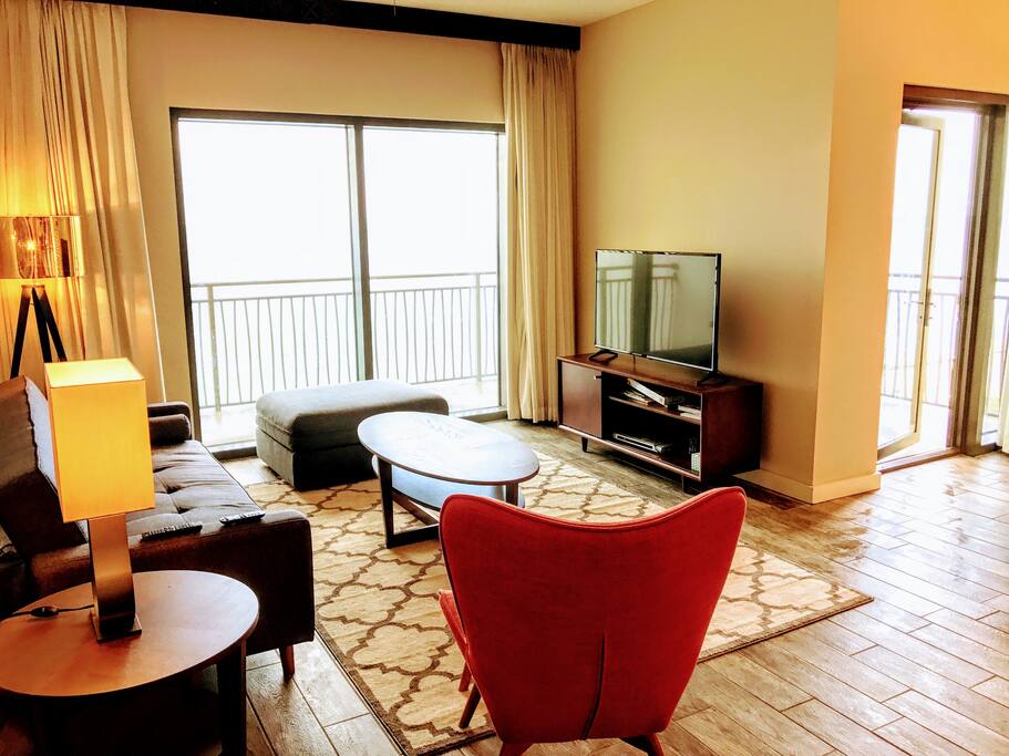 Living room surrounded by L shaped balcony with spectacular gulf views & free netflix