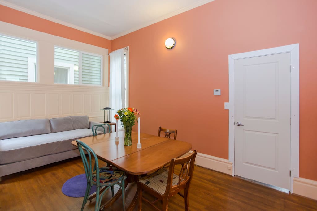 A separate dining room adjoins the living room. The daybed doubles as a single bed.