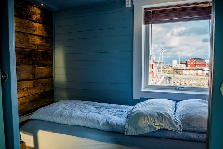 Bedroom 2 - with a beautiful view and original timber wall.