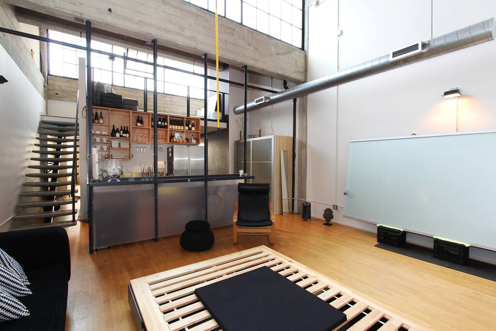 Grand room with view into kitchen and loft lounge