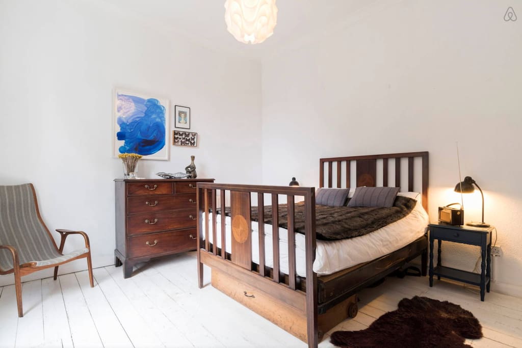 The master bedroom has an antique chest of drawers...