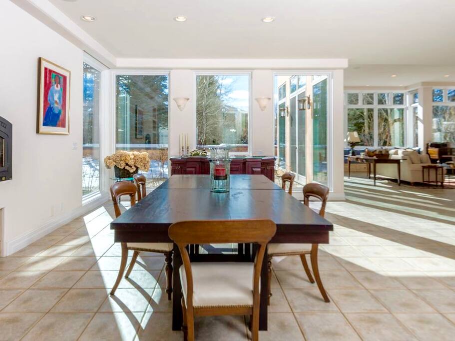 Dining area seats 14-16 comfortably at two adjacent tables. Dining area also has a wood fireplace.