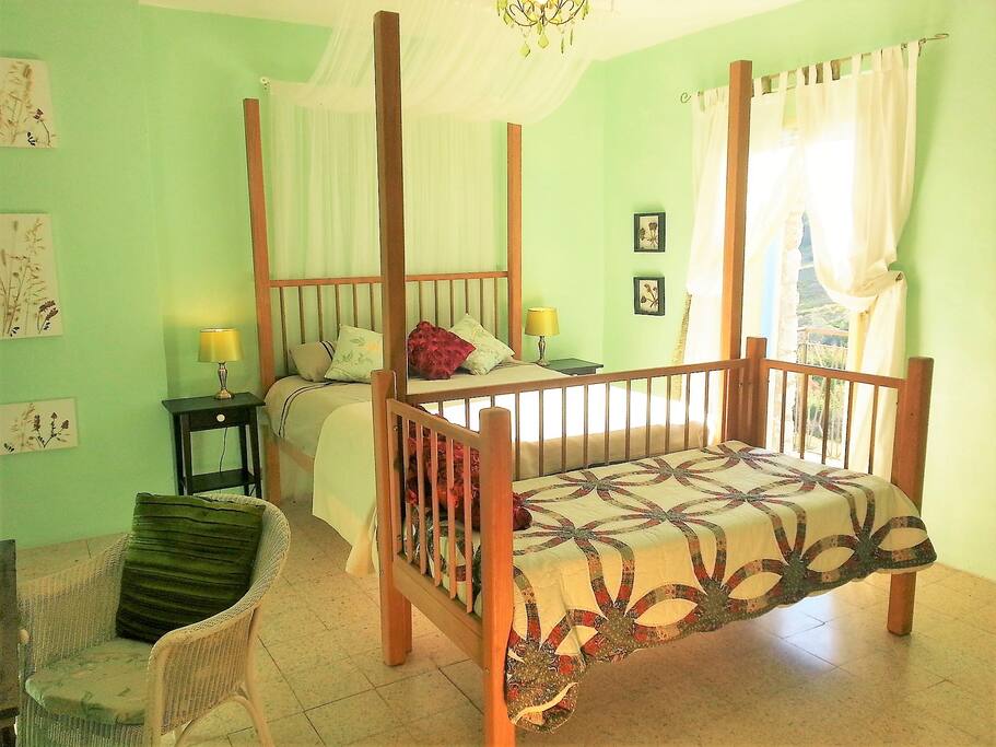 Master bedroom, four poster bed, day bed and ensuite bathroom