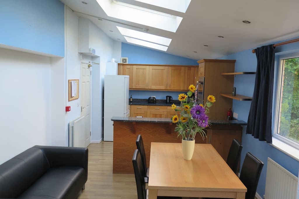 the lounge with the kitchen in the background