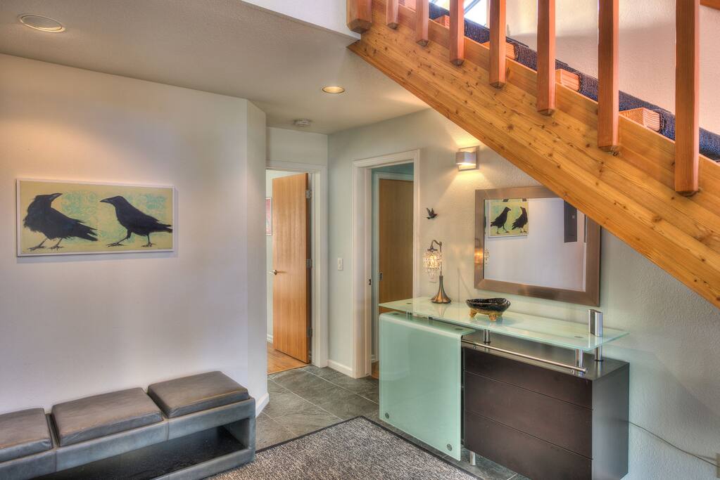 Entry way to reverse floor plan home; 2 of 3 bedrooms are on lower level
