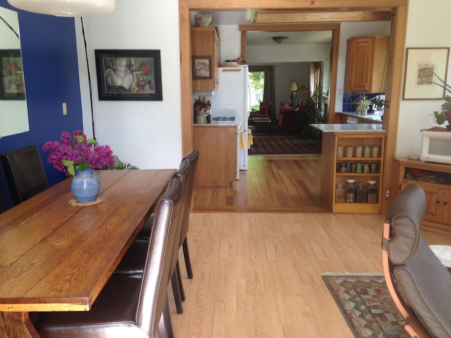 Sunny dinning-room connected to full kitchen.