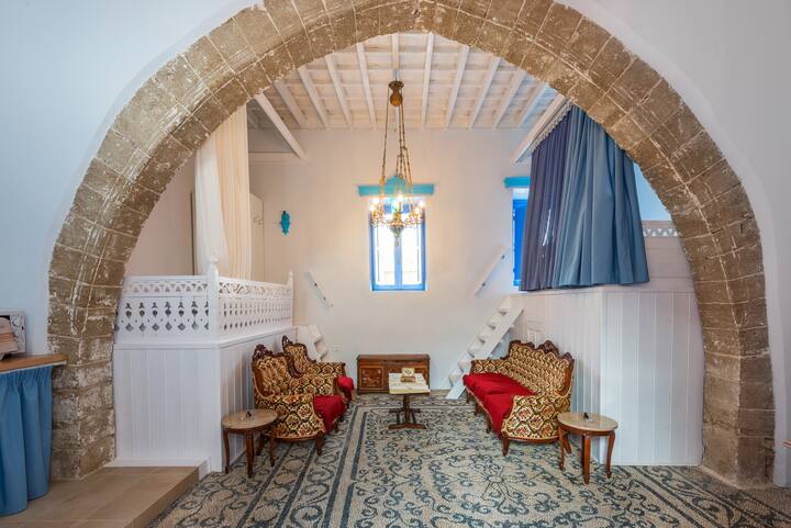 Louloudi Traditional House. Amazing atmosphere of this house, which was lately renovated but still keep original features like pebble floor, high ceiling, two double beds elevated on the sides of the main room.