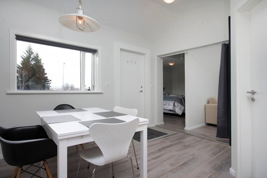 The kitchen table and the hall. There are other, brand new chairs now. On the right is a view into the bedrooms.