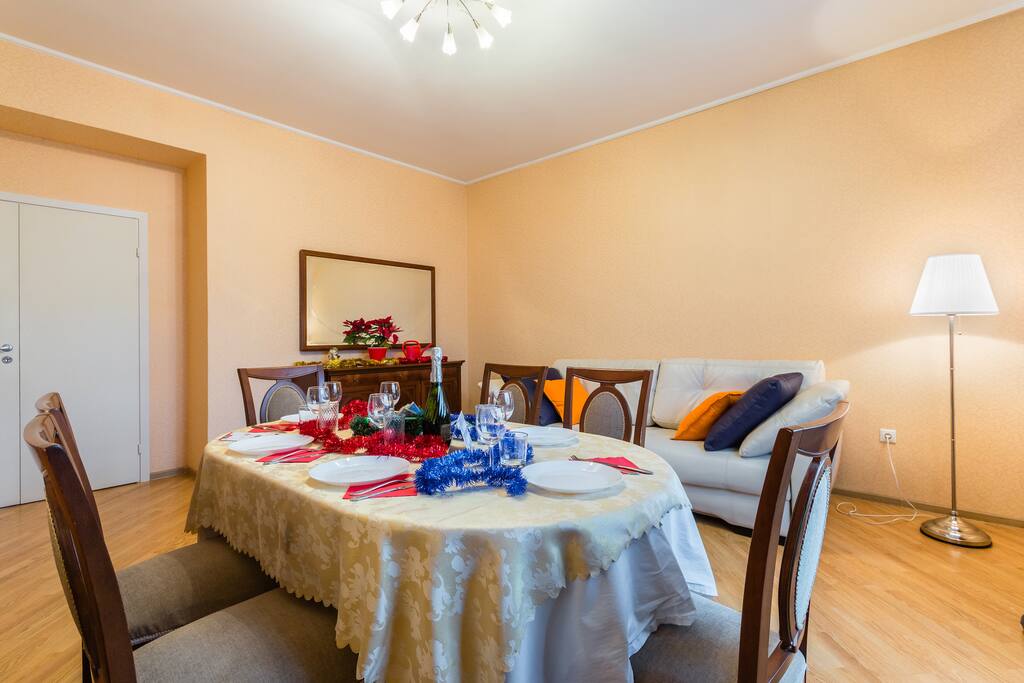 Living room has a large dining table and new, white leather sofa-bed (sleeping place 160x200)