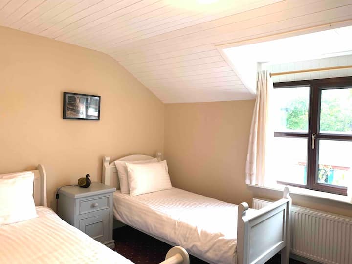 This is Room Number 2 with two hand-crafted beds and a nightstand.  The dimensions of each mattress are approximate: length, 1.9.5 m (6’5”)  by width 1 m (3’1”).  This room has its own toilet and shower inside the room, same size as the other. 