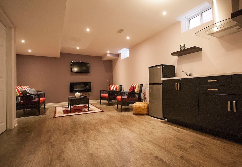 Private spacious living room with a fire place and Apple TV