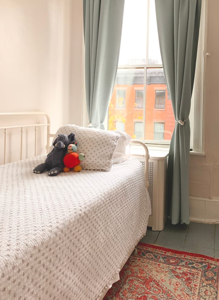 Small second bedroom is entered via the primary bedroom—the comfortable twin bed has a trundle bed that can slide out. The room is small, it is very tight when the trundle is pulled out!) We can also set a pack n play crib up for babies.