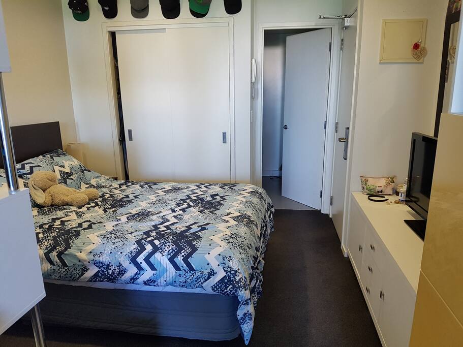 Bed and Bathroom behind