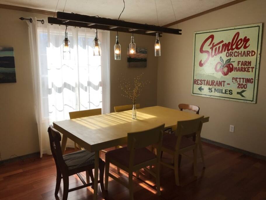 Dining room that seats 8 with 2 stools at kitchen counter