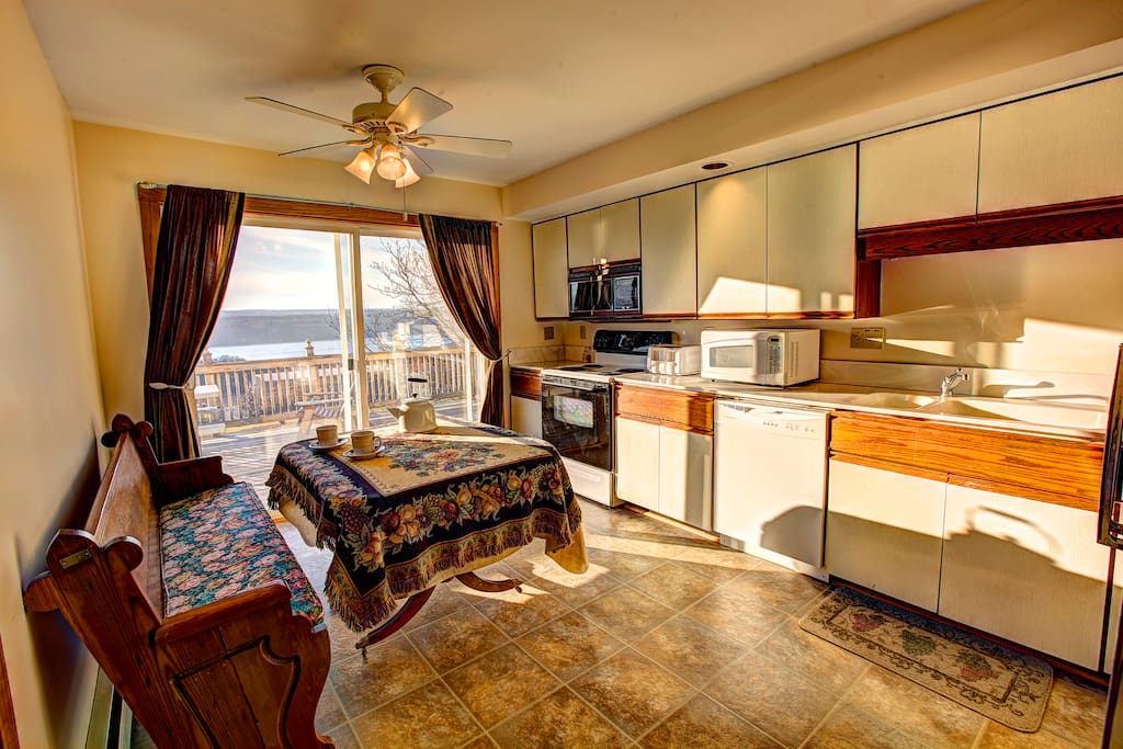 Kitchen with views of the lake and sliding doors to a wrap-around deck.