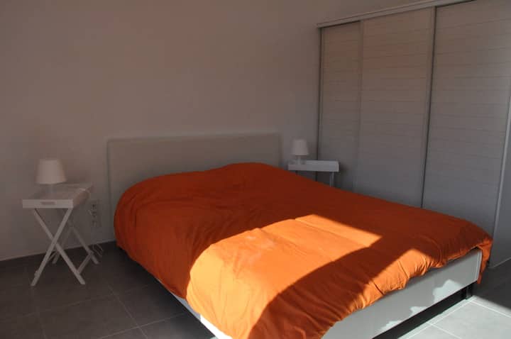 Orange bedroom with double bed