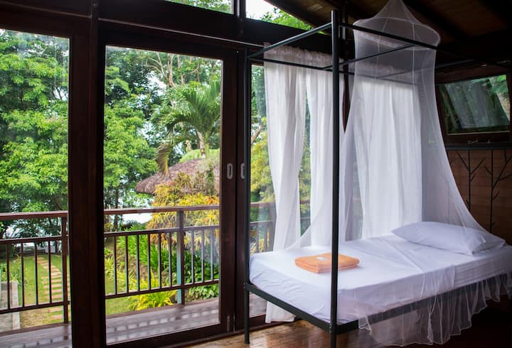The view of the pool and hillsides from inside one of our two bedrooms facing the lake.