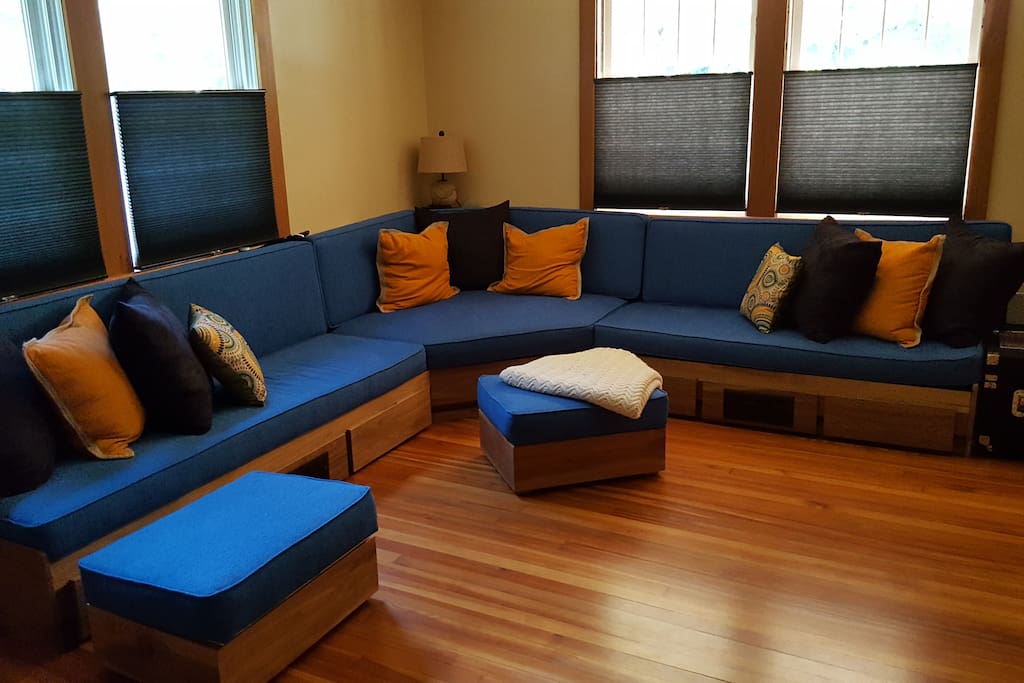 Whether you want to settle in for an epic movie night, gather with your traveling companions, or stretch out for a nap, the living space welcomes you to make the most of this custom-built couch and media center.