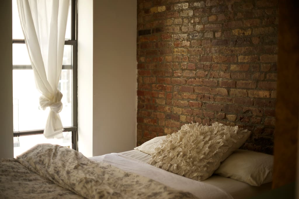 your bedroom exposed brick with two windows