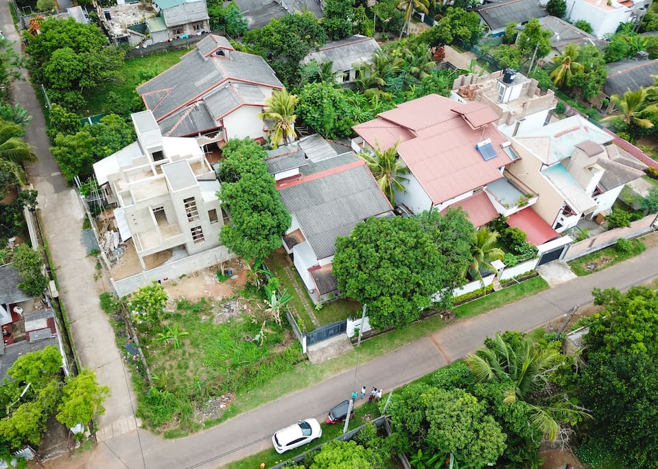 Aerial view of the property. The Grey roof with the Black gate close to the road. This not a main road, an it's extremely quiet.