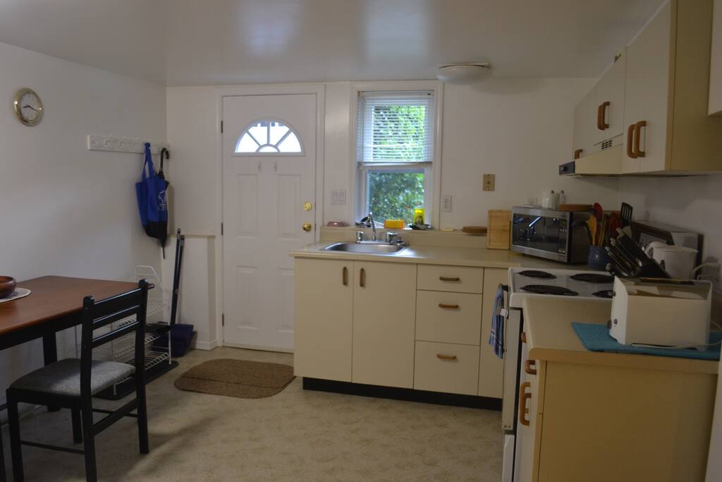 Fully equipped kitchen with microwave, stove/oven, kettle, toaster & fridge.