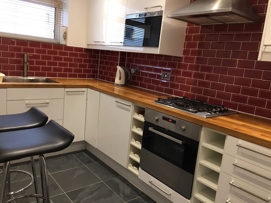 Kitchen with 2 bar stools and drop down table