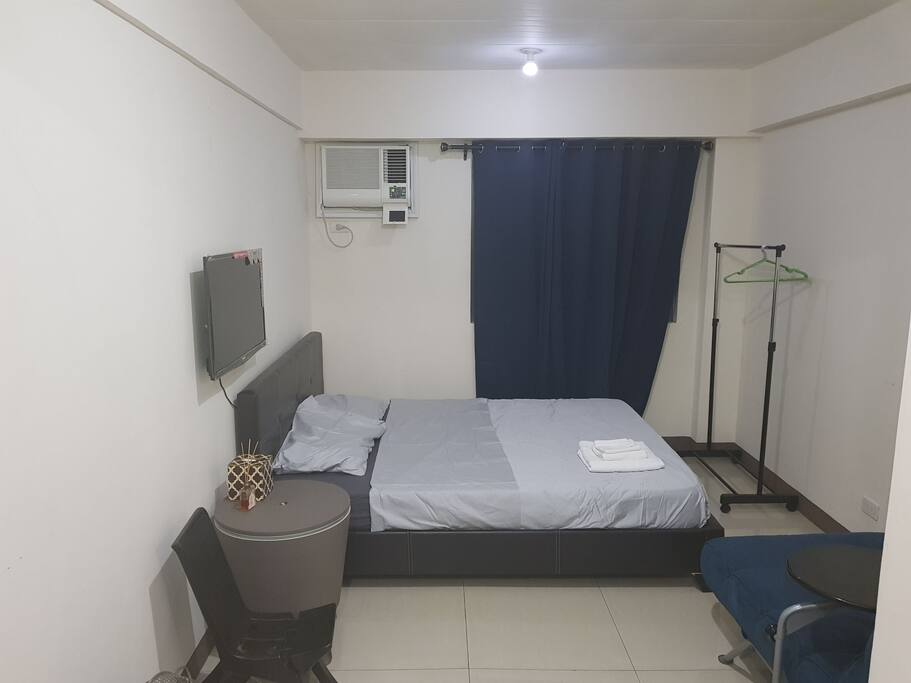 Queen Size Bed, Window type Air-conditioning, Wall mounted LED TV, Blackout curtains, Clothes Rack, Ketter Cooler as side table.