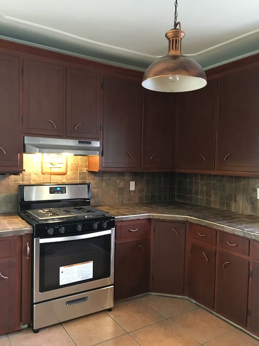 Kitchen with new stainless appliances and gas cooking.