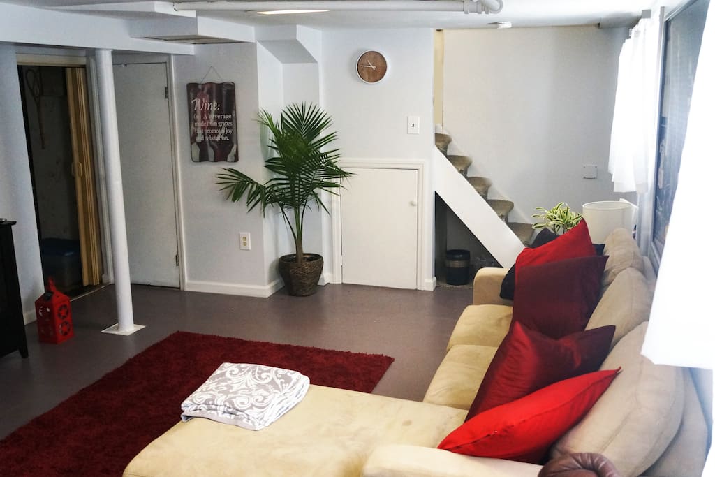 Living area with sofa and dining/ work desk.