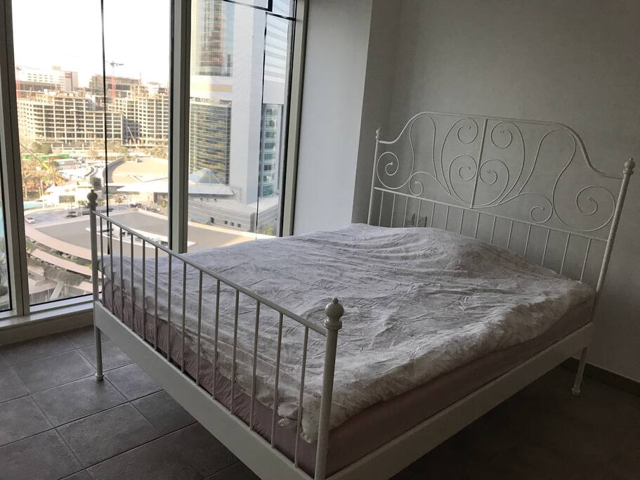 There are double bed, wardrobe, desk, coffee table in the room