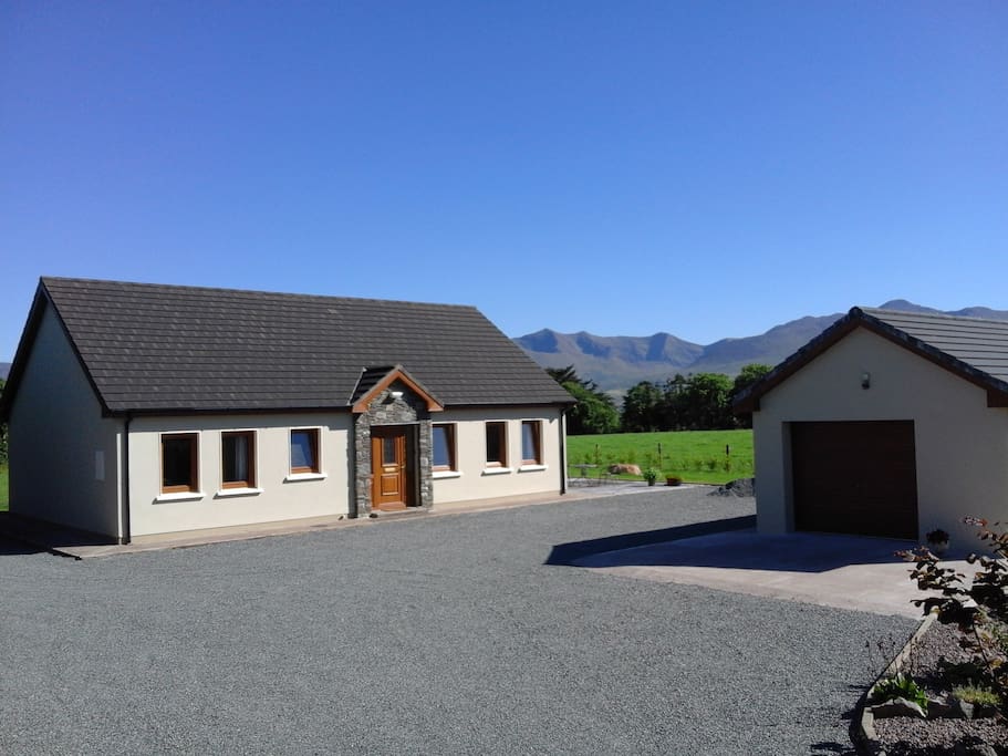 Front of house and garage with McGillycuddy Reeks mountains at rear.