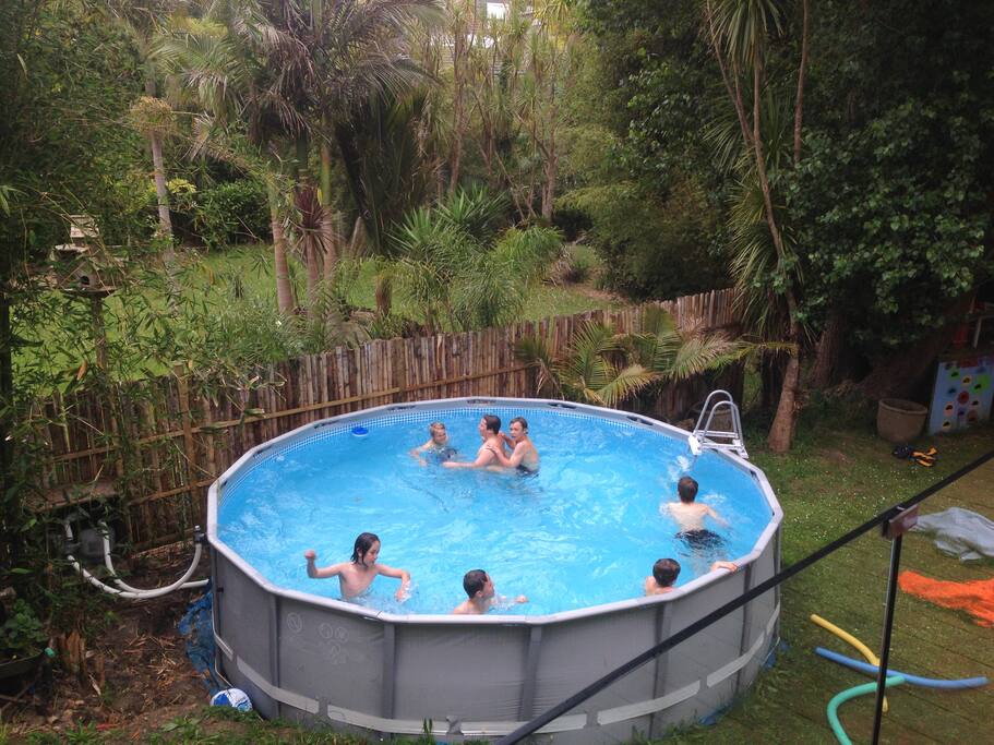 Large backyard with pool and trampoline