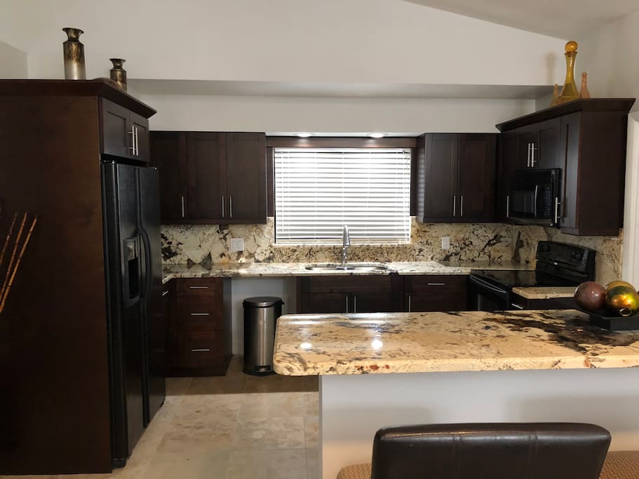 Beautiful exotic marble counter tops and full backs splash on brand new all wood cabinets.