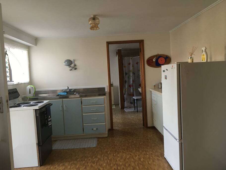 Full kitchen. View through to bathroom & laundry
