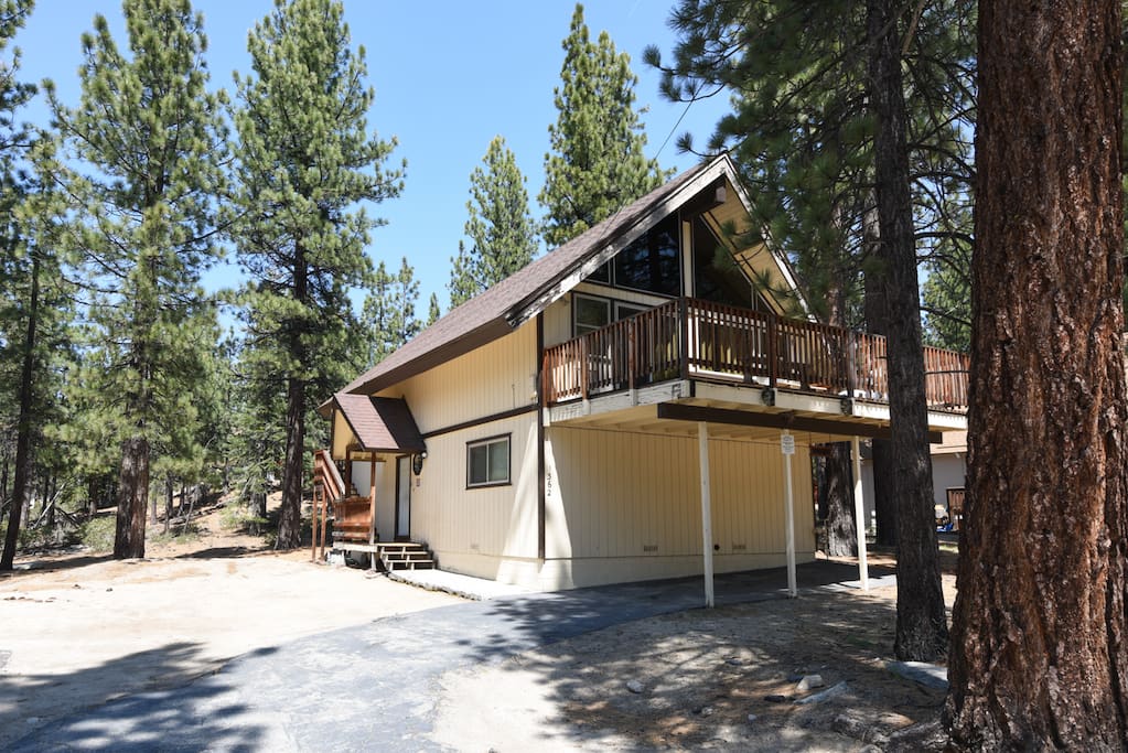 The front balcony in the trees has plenty of room for burgers flipped on the BBQ grill (provided).